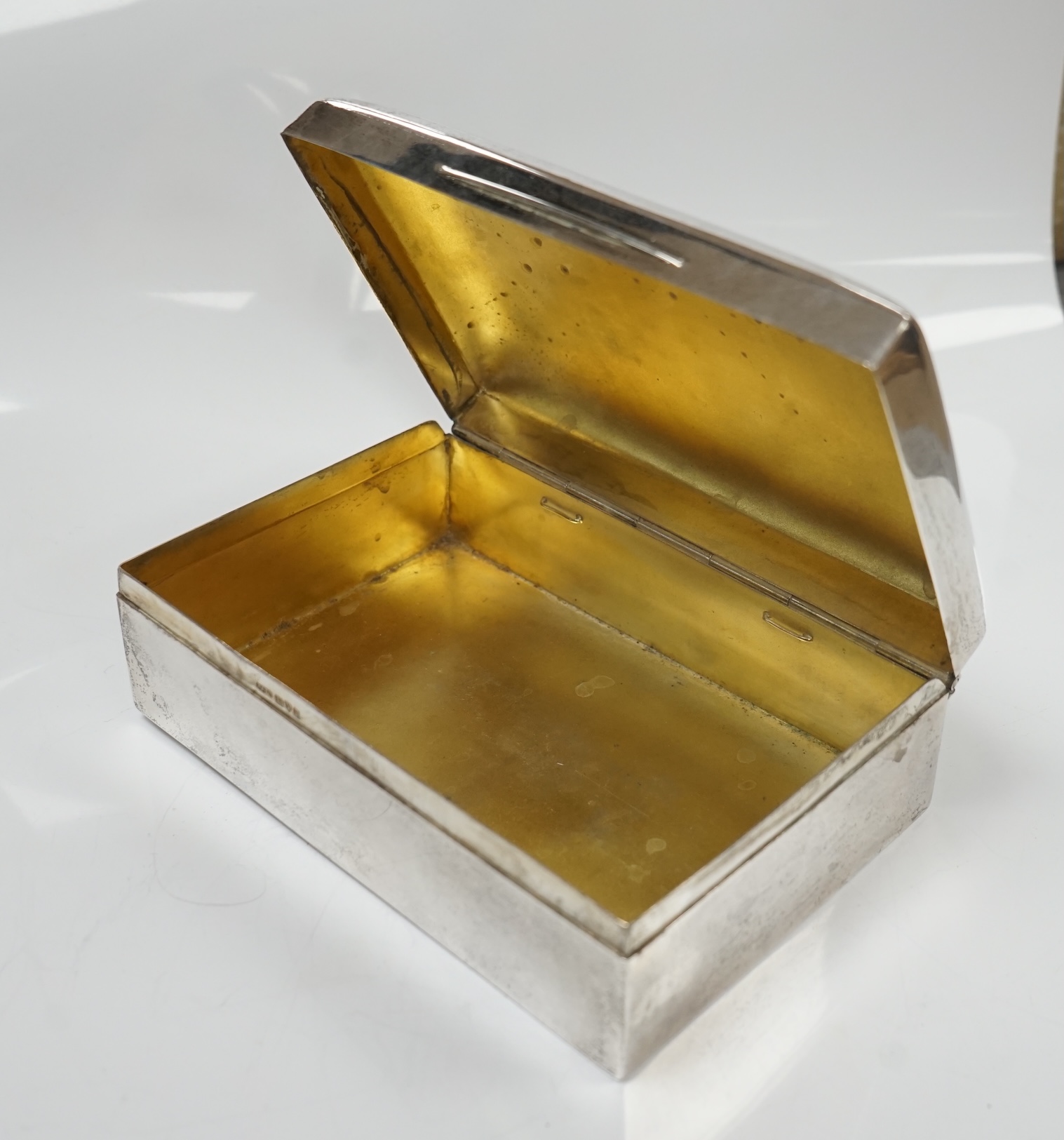 Two silver cigarette boxes, the largest by Stokes & Ireland, Chester, 1906, 14.7cm. Condition - poor to fair